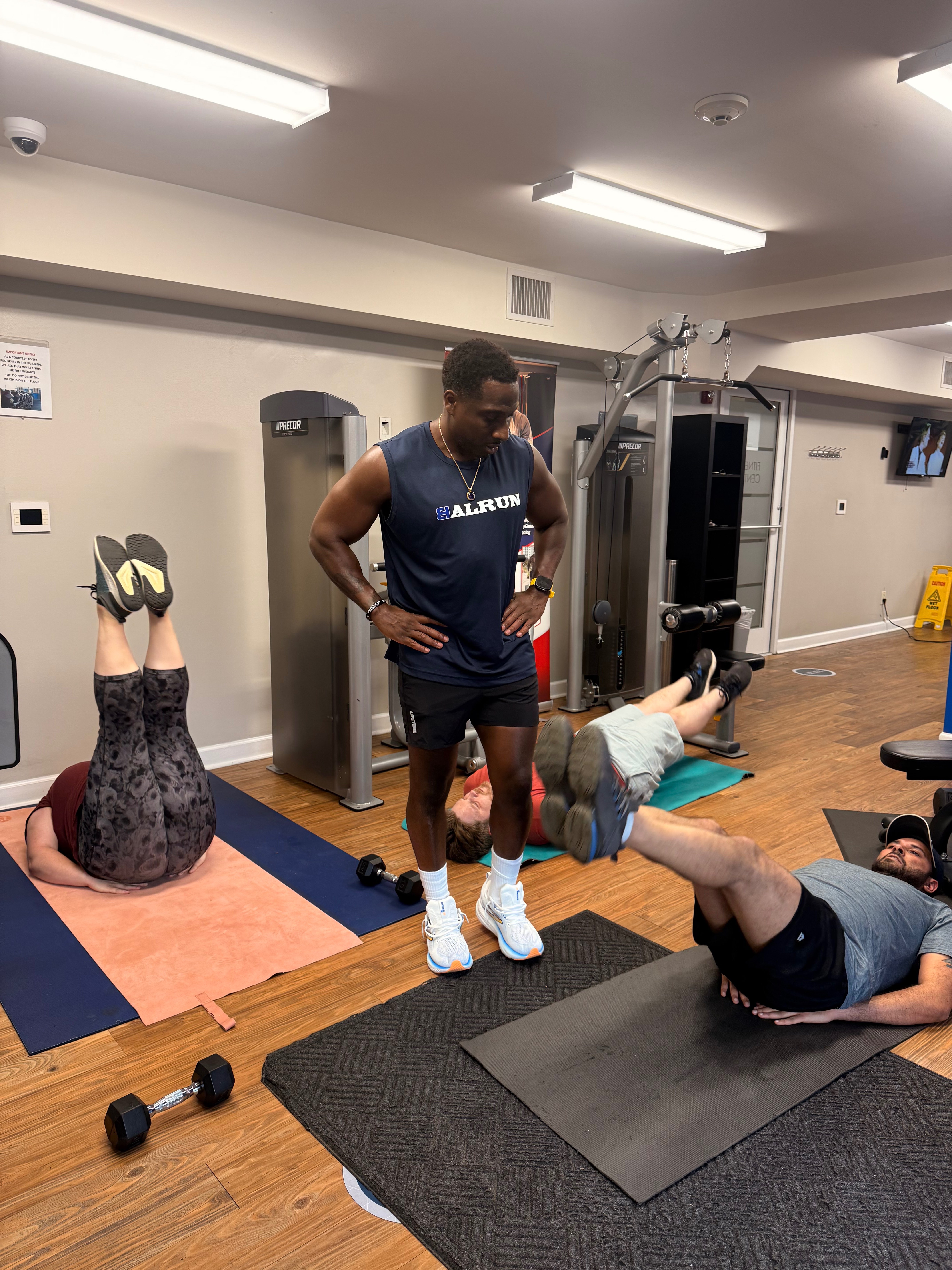 Coach Pat leading a small group training session in residential fitness center