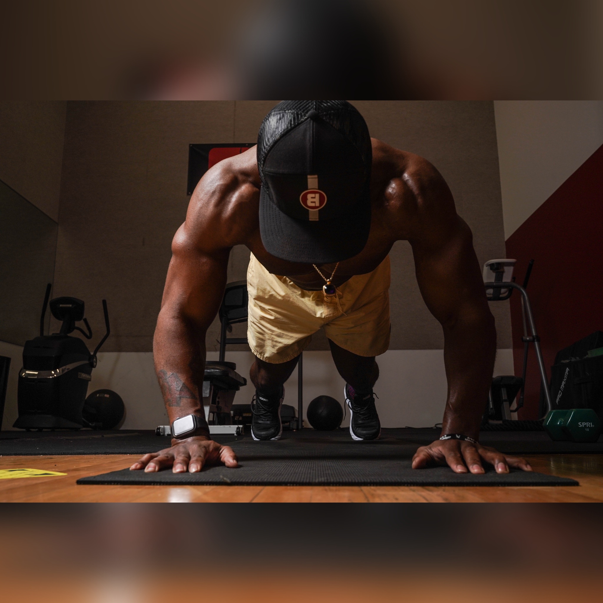 Coach Pat demonstrating plank position in BALRUN training facility