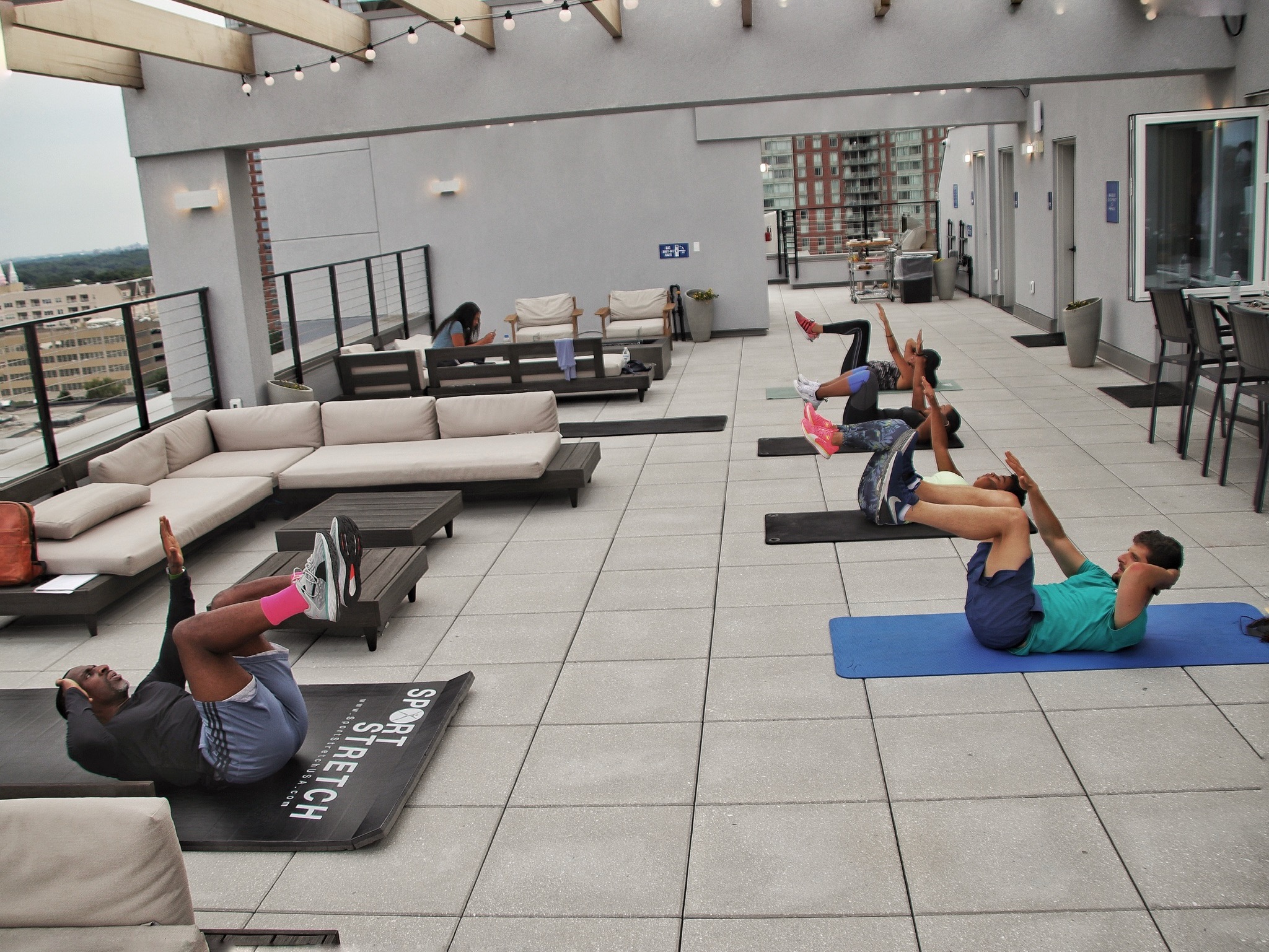 Community rooftop fitness class with BALRUN